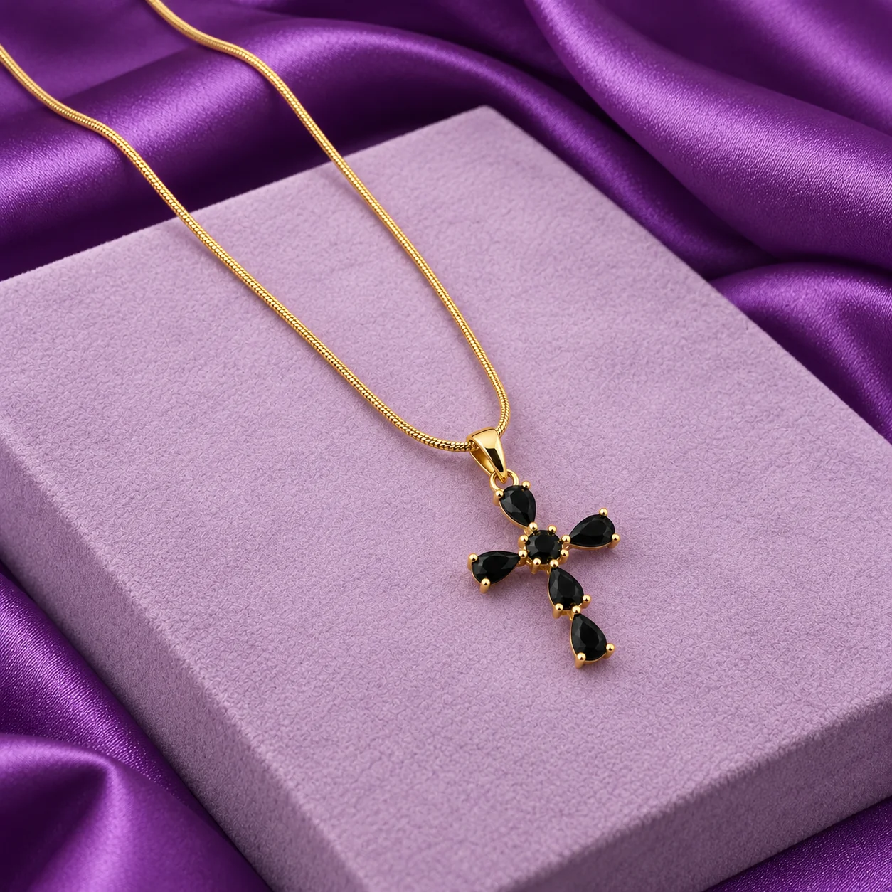 Black Cross Necklace, angled flatlay on stand.