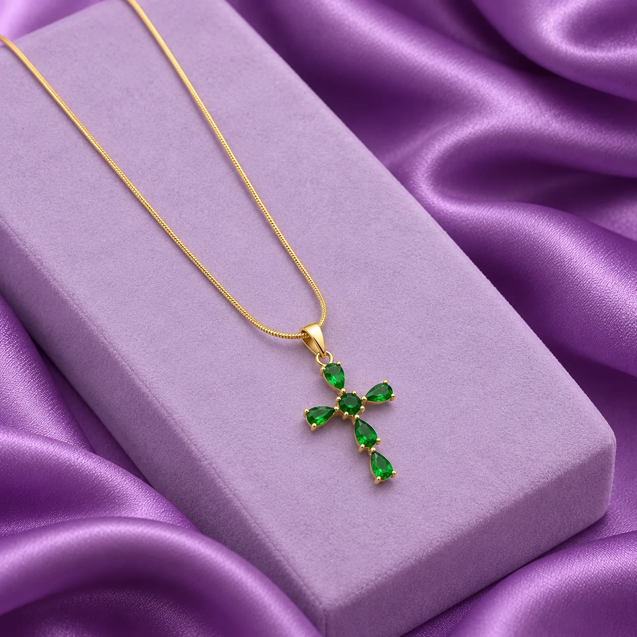 Green Cross Necklace, angled flatlay on stand.
