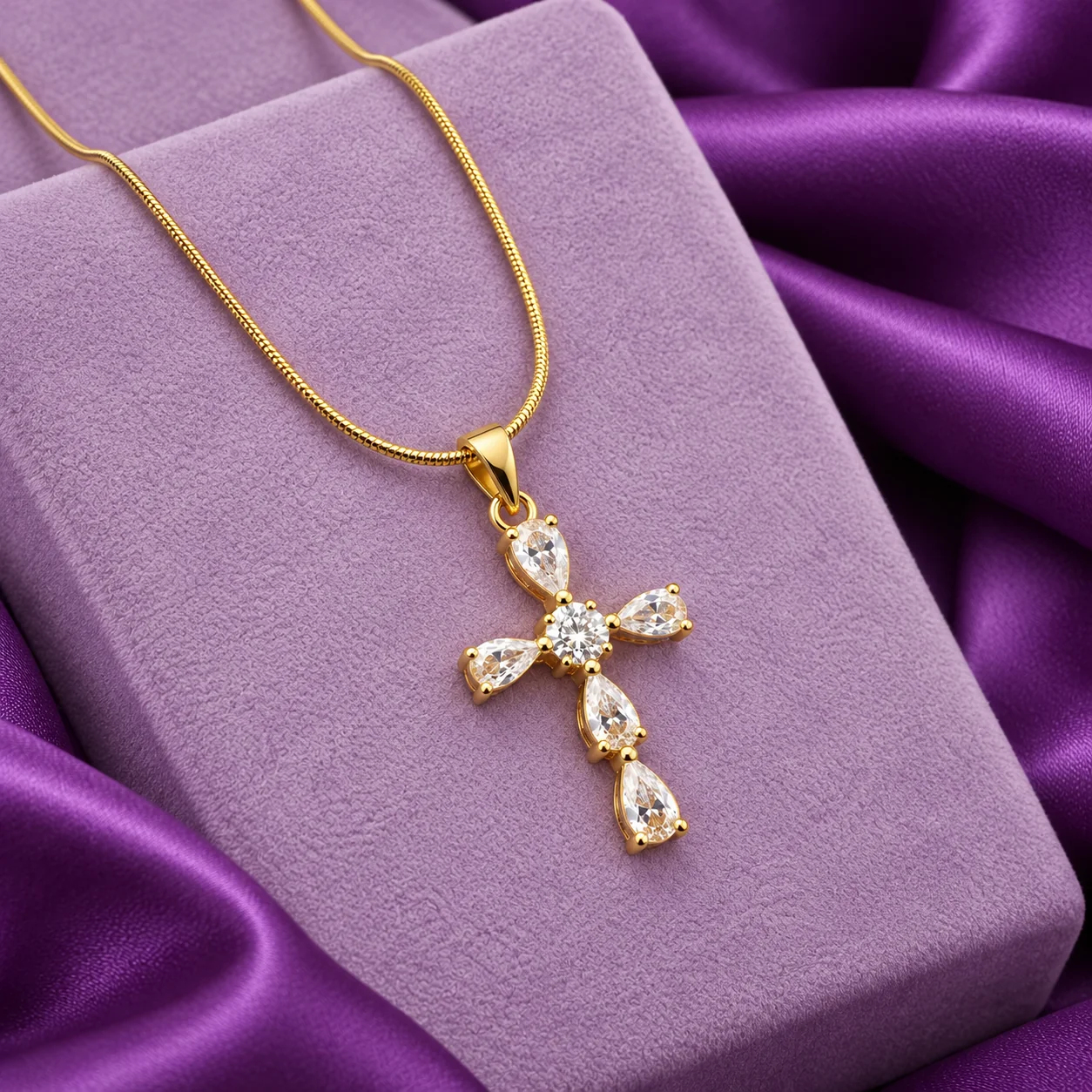 Marquise Pear Cross Necklace, angled flatlay on stand.
