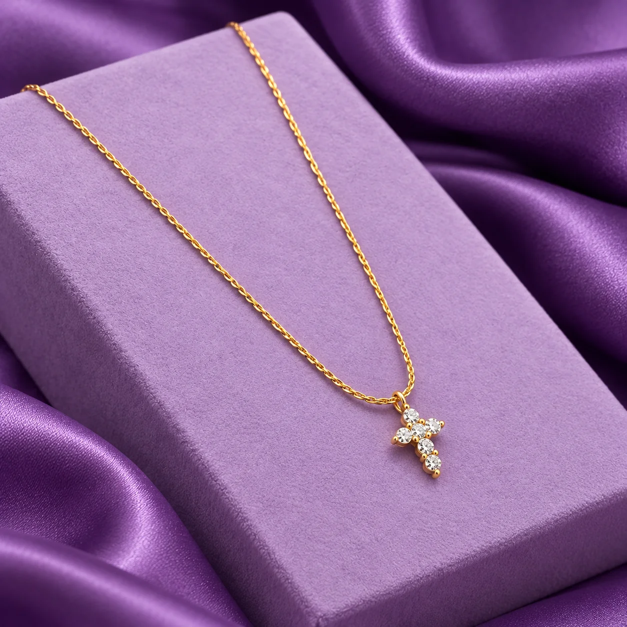 Petite Rope Chain Cross Necklace, angled flatlay on stand.